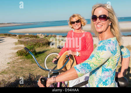 Caucasian women riding bicycles together Stock Photo