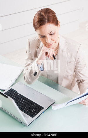 Mature Businesswoman Working in Office Stock Photo