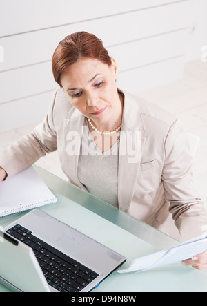 Mature Businesswoman Working in Office Stock Photo