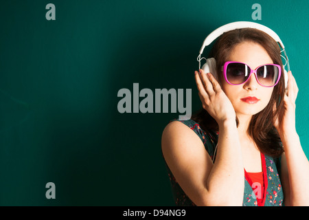 Portrait of Young Woman Wearing Headphones in Studio Stock Photo