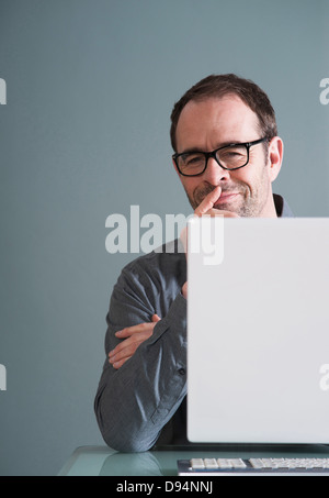 Buisnessman Using Computer in Studio Stock Photo