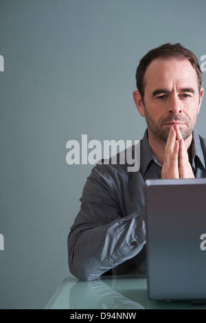 Buisnessman Using Laptop in Studio Stock Photo