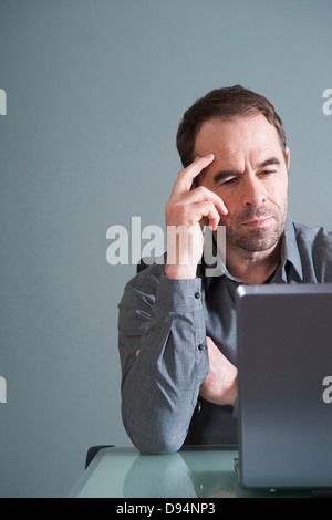 Buisnessman Using Laptop in Studio Stock Photo