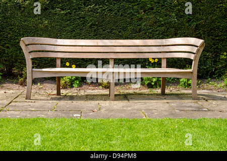 Empty wooden bench in English country garden Stock Photo