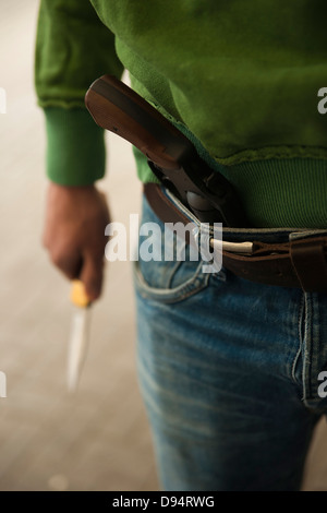 Man with gun tucked in pants isolated on white Stock Photo - Alamy