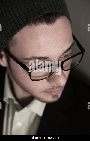 Close-up, High Angle View of Young Man wearing Woolen Hat and Eyeglasses, Studio Shot Stock Photo