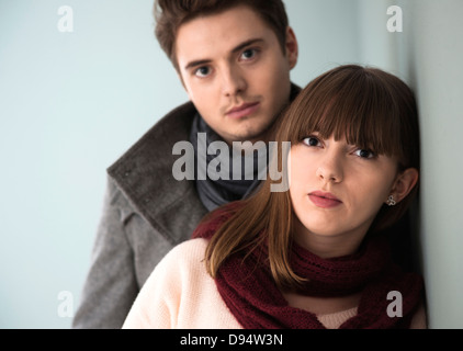 Head and Shoulder Portrait of Young Couple Looking at Camera, Studio Shot on Grey Background Stock Photo