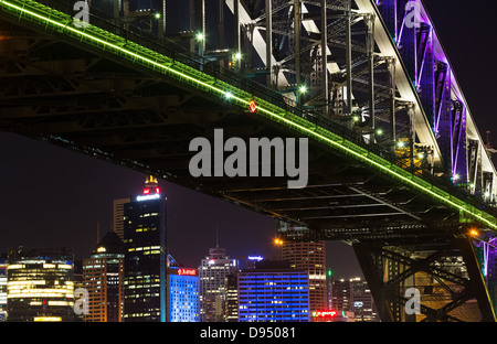 Skyscrapers viewed from under the Sydney Harbour Bridge at night, Sydney, Australia Stock Photo