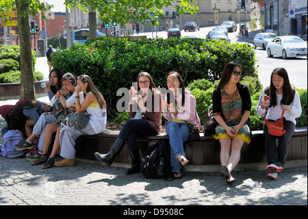 Young women sitting on bench in Bristol city Centre Promenade Stock Photo