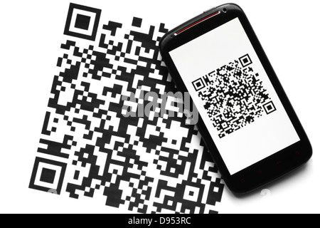 A mobile phone next to a QR code printed on paper Stock Photo