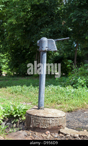 Old public hand water pump outdoors Stock Photo