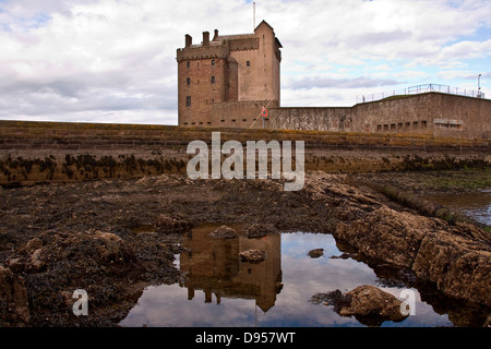 Reflections of Broughty Ferry Castle on the water of a large rock pool at low tide near Dundee,UK Stock Photo