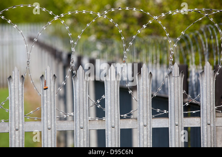 Spiked metal railings and razor wire around a secure compound Stock ...