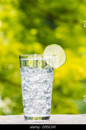 clear fresh water in glass with large ice cubes outdoors Stock Photo