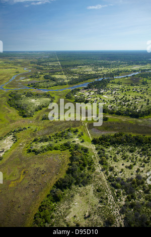 Buffalo fence (disease control fence) separating wildlife from domestic cattle, and Boro River, Okavango Delta, Botswana, Africa Stock Photo