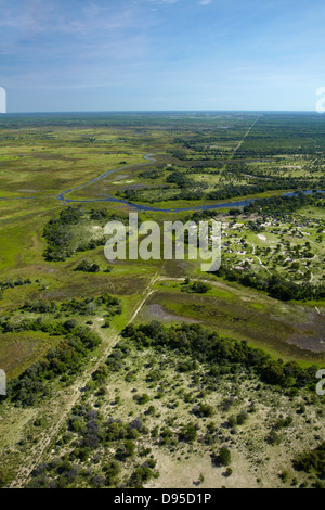 Buffalo fence (disease control fence) separating wildlife from domestic cattle, and Boro River, Okavango Delta, Botswana, Africa Stock Photo