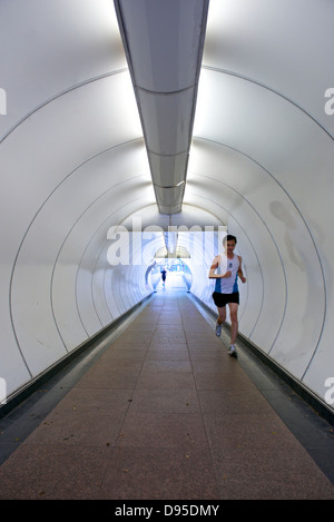 Man running through a tunnel in Singapore Stock Photo