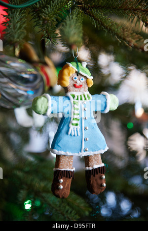 decorated gingerbread woman hanging as an ornament on a Christmas tree, Canada Stock Photo