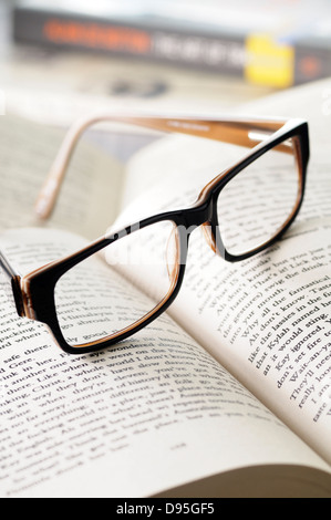 Close-up of Eyeglasses on Open Book Stock Photo