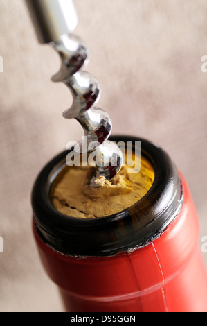 Close-up of Corkscrew Opening Bottle of Wine Stock Photo