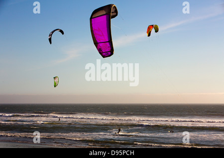 Kite surfers out in waves in afternoon sunshine on California coast near Big Sur, USA Stock Photo