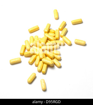 yellow pills cut out onto a white background Stock Photo