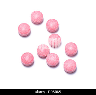 pink pills cut out onto a white background Stock Photo