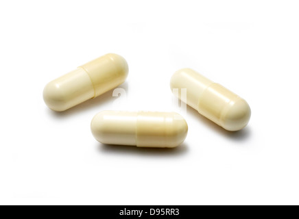 white capsules cut out onto a white background Stock Photo