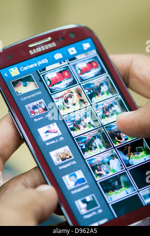 Viewing photos in smartphone Stock Photo