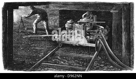 Hydraulic coal cutting machine, named 'The Iron Man', in position on rail track undergground in a coal seam. Made by Carrett, Marshall & Co., and shown at the Paris International Exposition of 1867. Wood engraving. Stock Photo
