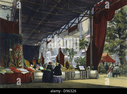 Great Exhibition, Hyde Park, London, 1851. Interior view of the Crystal Palace showing two visitors being shown a stand of oriental products. In the right hand front corner a man and woman admire plants in a Wardian case.  Coloured engraving. Stock Photo
