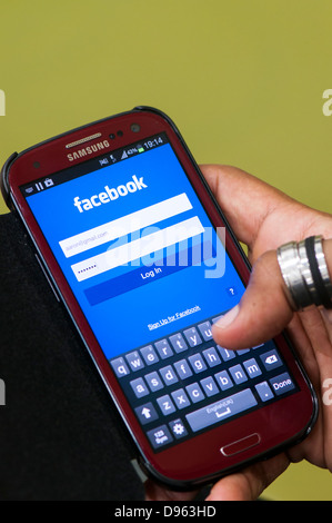Facebook login screen on mobile phone Stock Photo