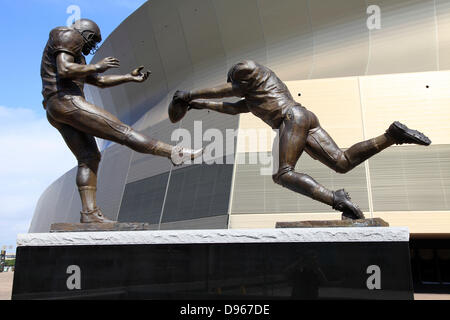 Sculpture of football players in front of the Superdom. A really gigantic gymnasium is the Superdom of New Orleans.  It has about 95.000 places. Since October 23, 2011, the Superdom is renamed to Mercedes-Benz Superdom. The native football-team New Orleans Stock Photo