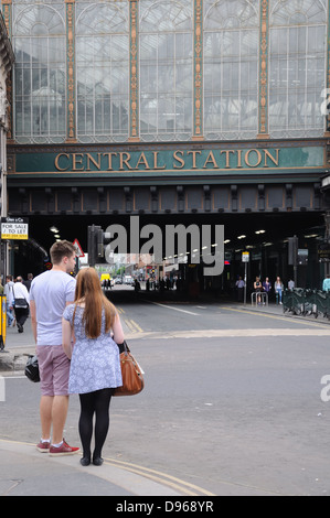 Young man and young lady standing on Kerbside at Glasgow central station bridge on Argyle Street, Glasgow, Scotland, UK Stock Photo