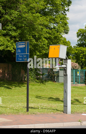 A speed camera and sign indicating a bus lane Stock Photo