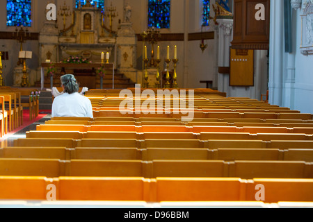 People sitting and praying inside a christian church in Europe Stock ...