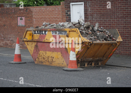 A skip full of building rubble, bricks, cement etc. Stock Photo