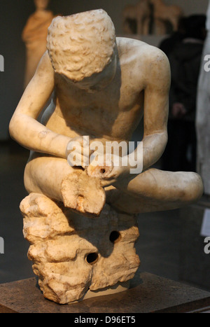 Marble statue of a boy, also known as the 'spinario', or thorn-puller. circa 25-50 AD, Roman copy of a lost Hellenistic work from 3rd century BC. Stock Photo