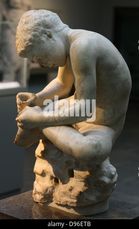 Marble statue of a boy, also known as the 'spinario', or thorn-puller. circa 25-50 AD, Roman copy of a lost Hellenistic work from 3rd century BC. Stock Photo