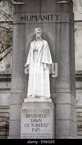 Memorial statue of Edith Cavell, British nurse and patriot. Set at Saint Martin's Place in London, England. Made of White marble against a tall granite cross. Made by Sir George Frampton and unveiled in 1920 Stock Photo