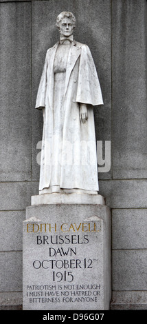 Memorial statue of Edith Cavell, British nurse and patriot. Set at Saint Martin's Place in London, England. Made of White marble against a tall granite cross. Made by Sir George Frampton and unveiled in 1920 Stock Photo