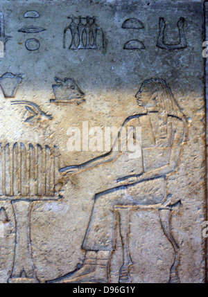Egyptian wall relief. Depicting figures playing a game of Senet. 26th Dynasty (approx. 600 BC) Egyptian. Stock Photo