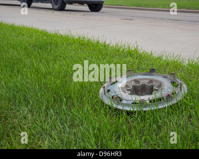 wheel cap fallen on the side of road Stock Photo