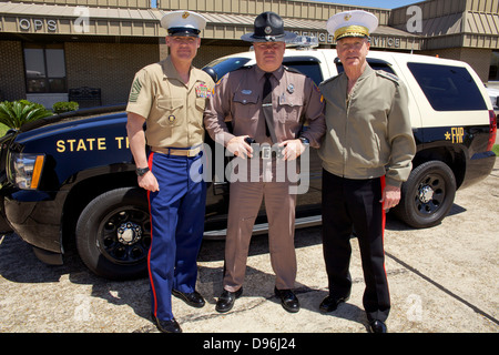 The 35th Commandant of the Marine Corps, Gen. James F. Amos, right, and 17th Sergeant Major of the Marine Corps, Sgt. Maj. Micheal P. Barrett, left, pose for a photo a Florida Highway Patrol officer after visiting the Marine Fighter Attack Training Squadr Stock Photo