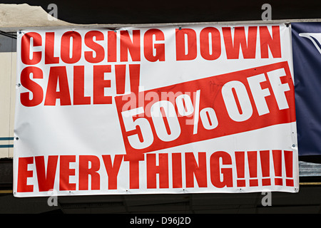 Closing down sale, 50% off everything, sign over shop window, UK Stock Photo