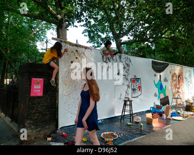 Artists work on their canvas' at the Howl! Festival's 'Art Around the Park' around Tompkins Square Park in NY's East Village Stock Photo