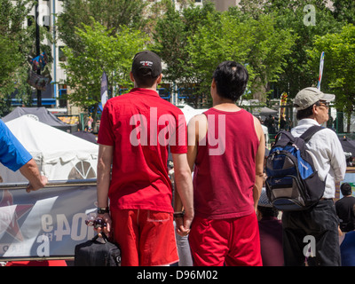 interracial gay couple holding hands at Edmonton pride festival Stock Photo