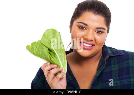 close up portrait of overweight teenage girl holding lettuce Stock Photo