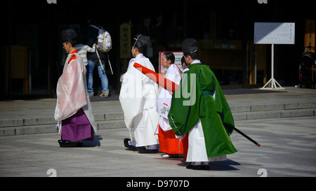 Kannushi and Miko walking back after performing religious rites for a traditional Japanese wedding at Meiji Shrine Stock Photo