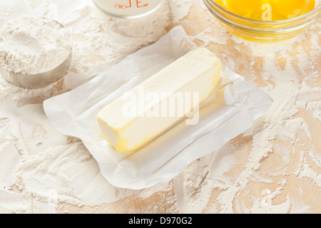 Fresh natural butter in front of baking ingredients Stock Photo